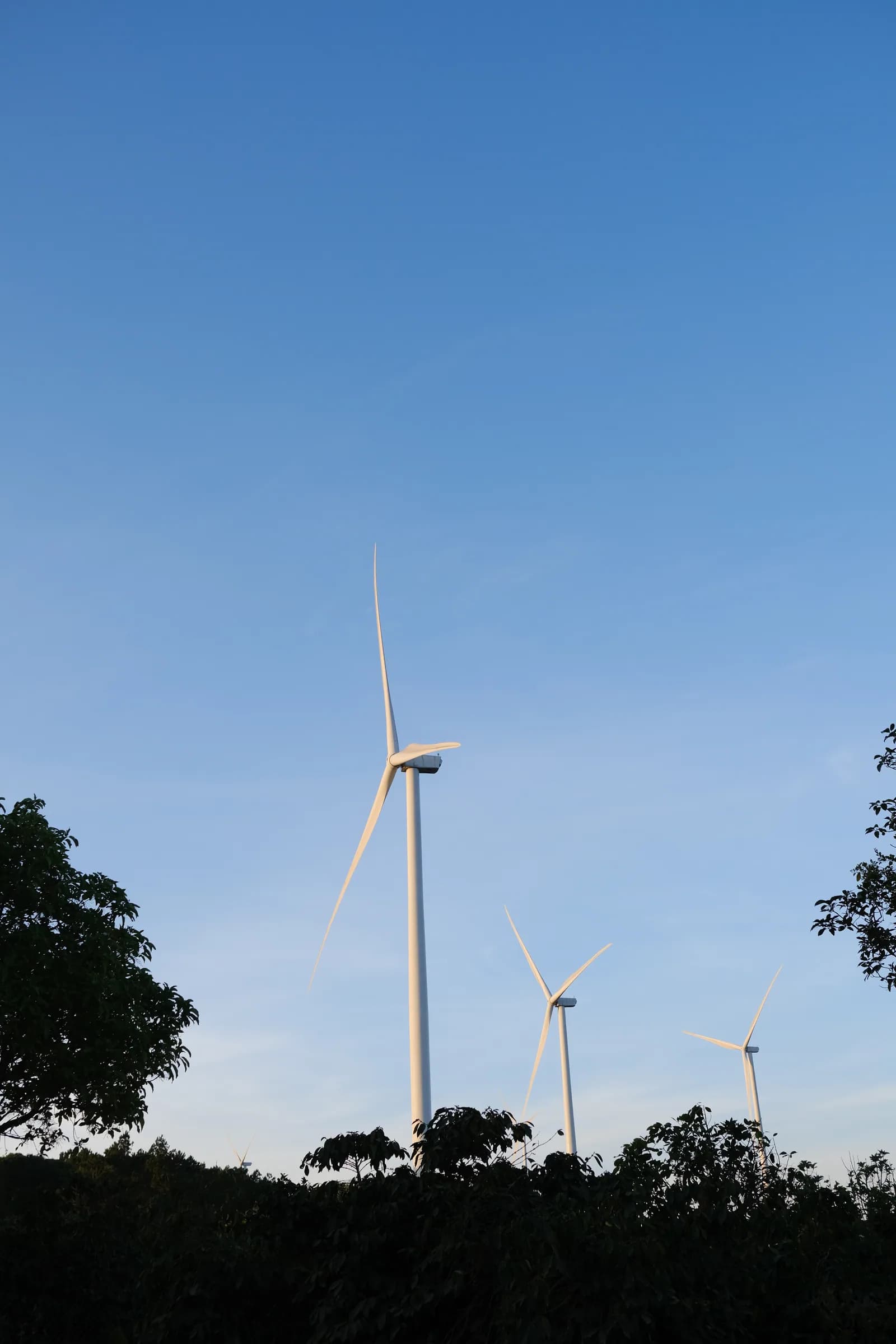 A wind turbine against a blue sky